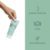 Hand holding Eucerin scrub with icons highlighting its benefits: non-comedogenic and scrub.