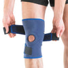 Person applying a knee support bandage with velcro straps on the knee.