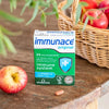 Vitabiotics Immunace Original on table with an apple beside the basket