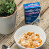 Wellman Prostace box (60 tablets) next to a bowl of cereal and a plant.