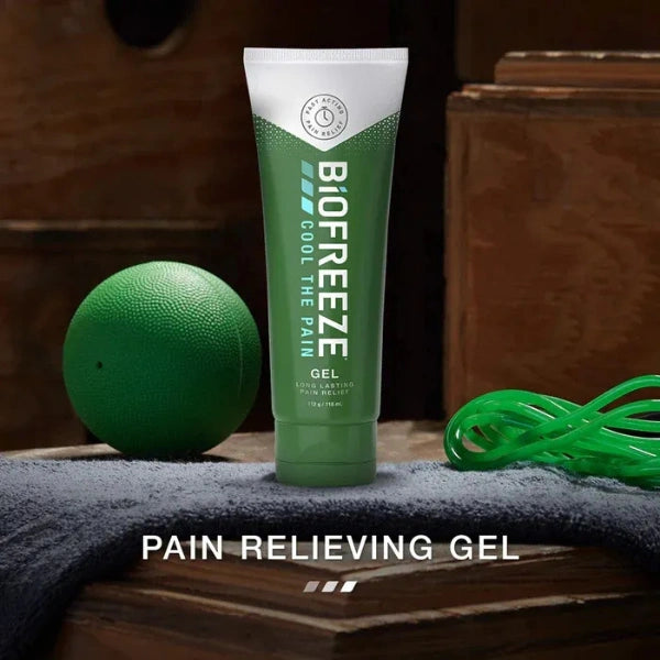 Biofreeze pain relieving gel tube with a green ball and rope on a wooden surface