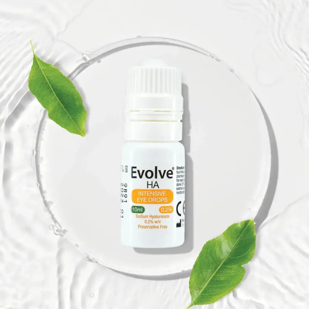 A bottle of Evolve HA Intensive Eye Drops centered on a white water-textured background with a circular clear ring and green leaves around it.