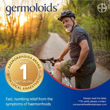 Man with bicycle on a path with 'Germoloids' branding and product claim text.