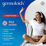 Promotional graphic for Bayer Germoloids cream for piles, featuring a woman sitting on a couch wearing white headphones and smiling, alongside product benefits on a blue background.