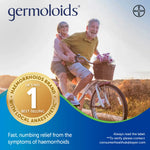 Bayer Germoloids advertisement featuring a smiling couple riding a bicycle outdoors, with the GERMOLOIDS brand name at the top, a gold UK No. 1 best-selling badge, and product text at the bottom on a blue graphic background.
