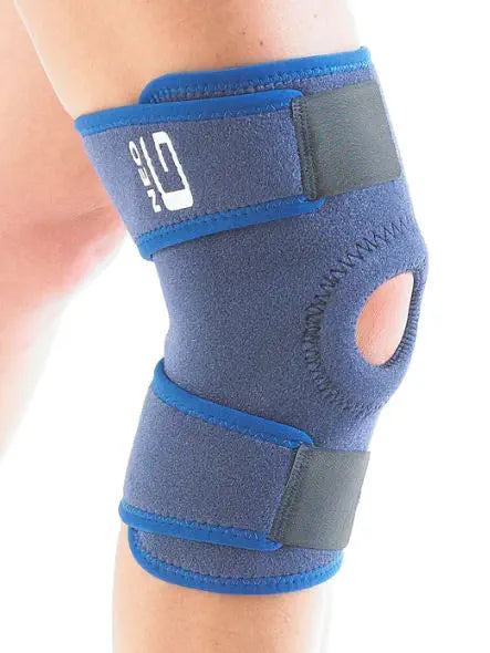 Knee support bandage in blue with a knee cap opening, secured with velcro straps.