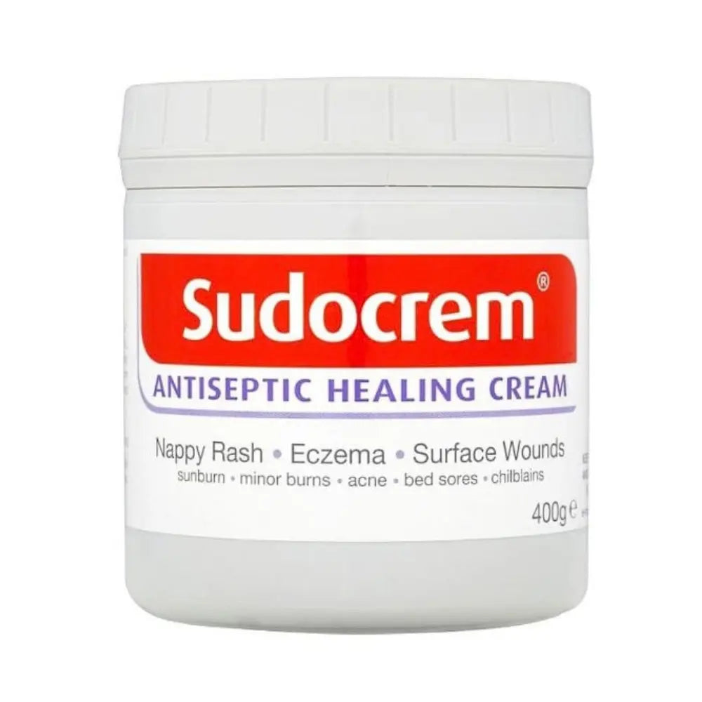 A white plastic jar of Sudocrem Antiseptic Healing Cream with a white lid, featuring a red and white label with purple text, on a plain white background.