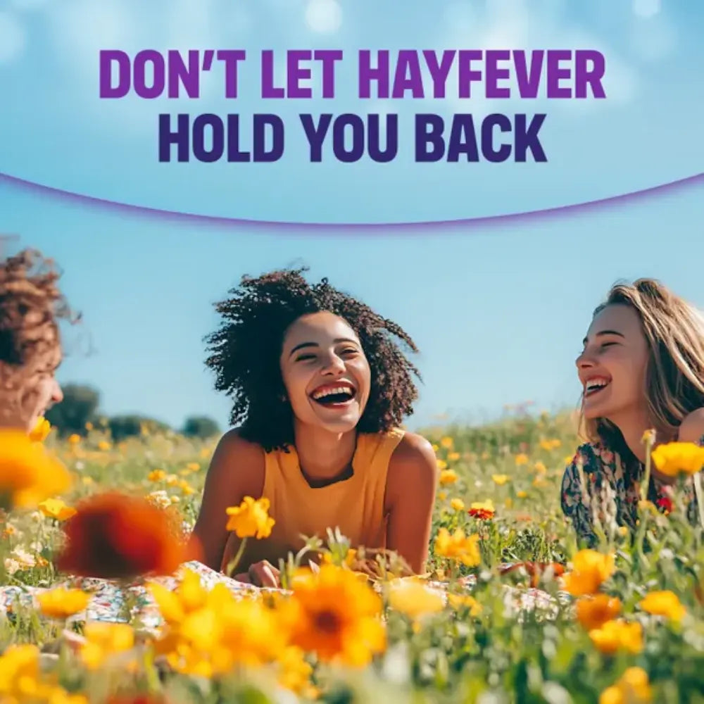 Three women laughing in a field of flowers with text 'Don't Let Hayfever Hold You Back' on a blue background.