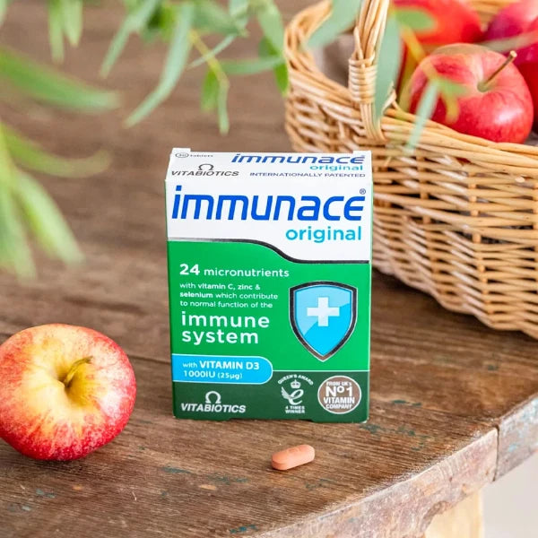 Vitabiotics Immunace Original on table with an apple beside the basket