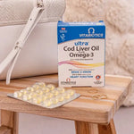 Vitabiotics Ultra Cod Liver Oil Plus Omega-3 with a blister pack of 60 capsules on a wooden table.