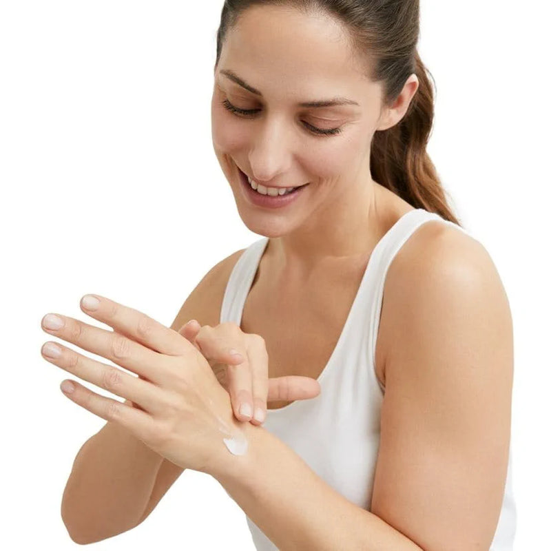 a girl is applying Eucerin Urea Repair Plus 5% Urea Hand Cream - 75mL