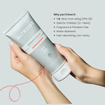 Altruist sunscreen tube held by a hand with product features listed on a light gray background