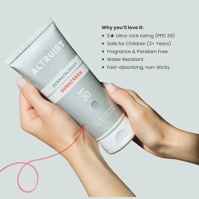 Altruist sunscreen tube held by a hand with product features listed on a light gray background