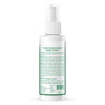 White spray bottle with green label on a white background