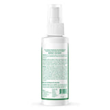 White spray bottle with green label on a white background