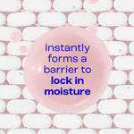 Pink soap bar with text 'Instantly forms a barrier to lock in moisture' on a white and pink background