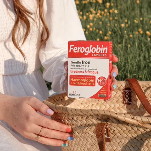 a girl is showing a vitabiotics feroglobin b12 30 capsules