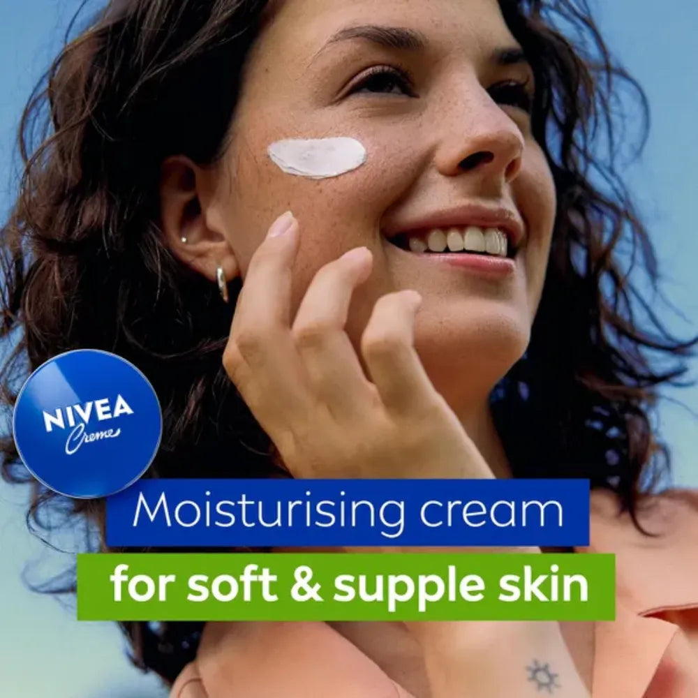 Woman applying Nivea moisturizing cream on her face with a blue background